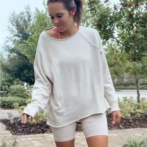 Cream sweatshirt with raw neck line and hem